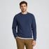 A man wearing a very soft handle sweater with ribbed collar and cuffs