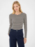 Woman wearing a Navy striped long-sleeve top with blue pants on a white background