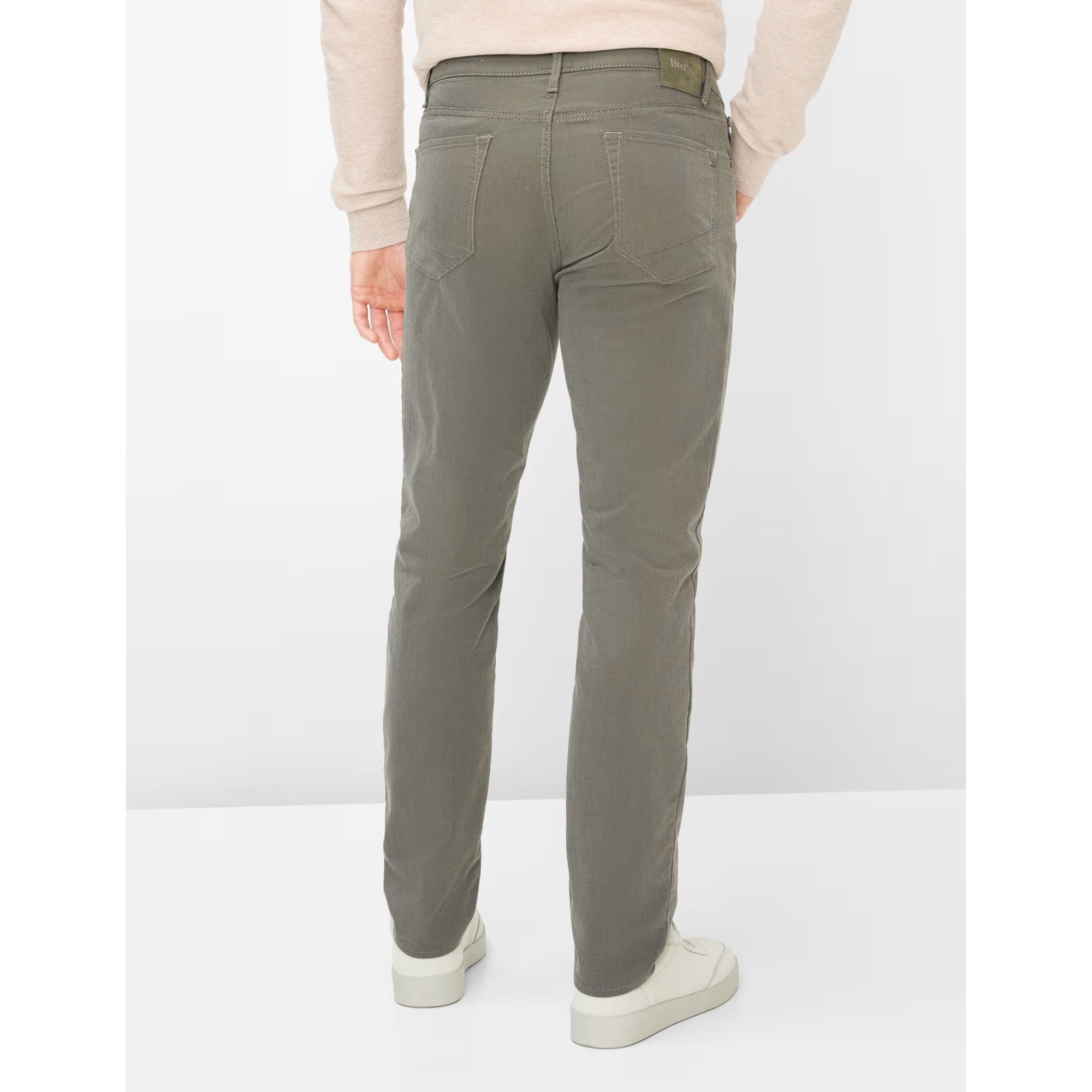 Person wearing gray pants on a white background