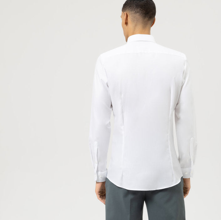 Man wearing a white dress shirt and gray pants on a light gray background