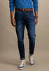 Person wearing blue jeans and a blue shirt with a brown belt on a beige background