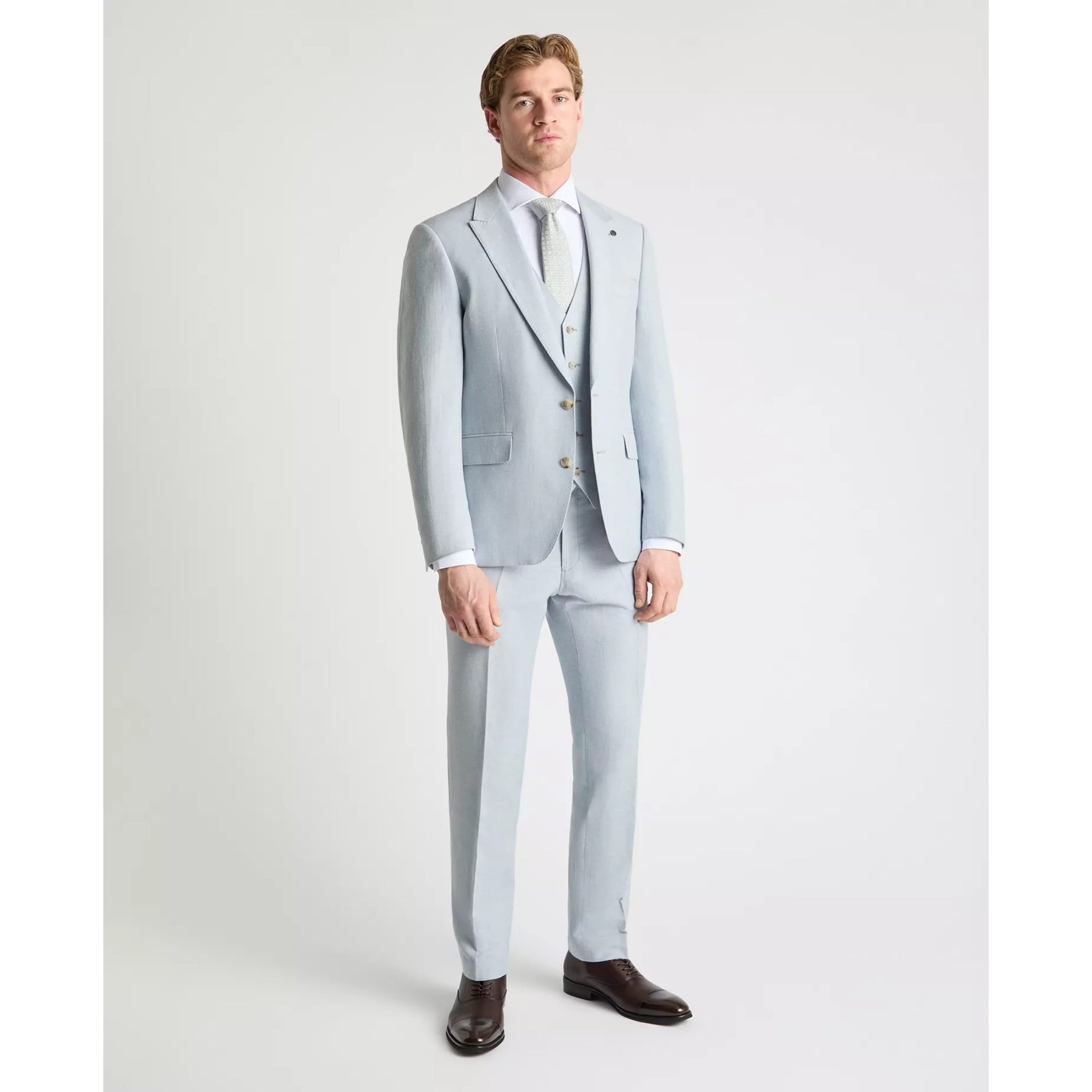 Man wearing a sky blue suit with a white shirt on a white background