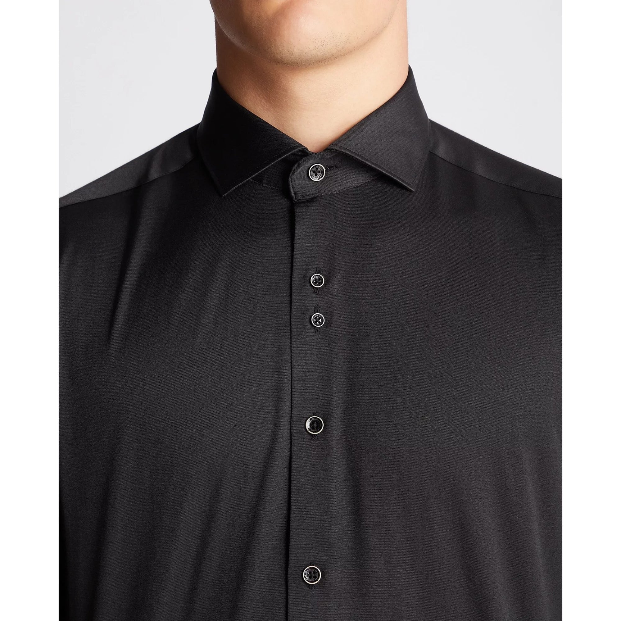 Black button-up shirt on a plain background