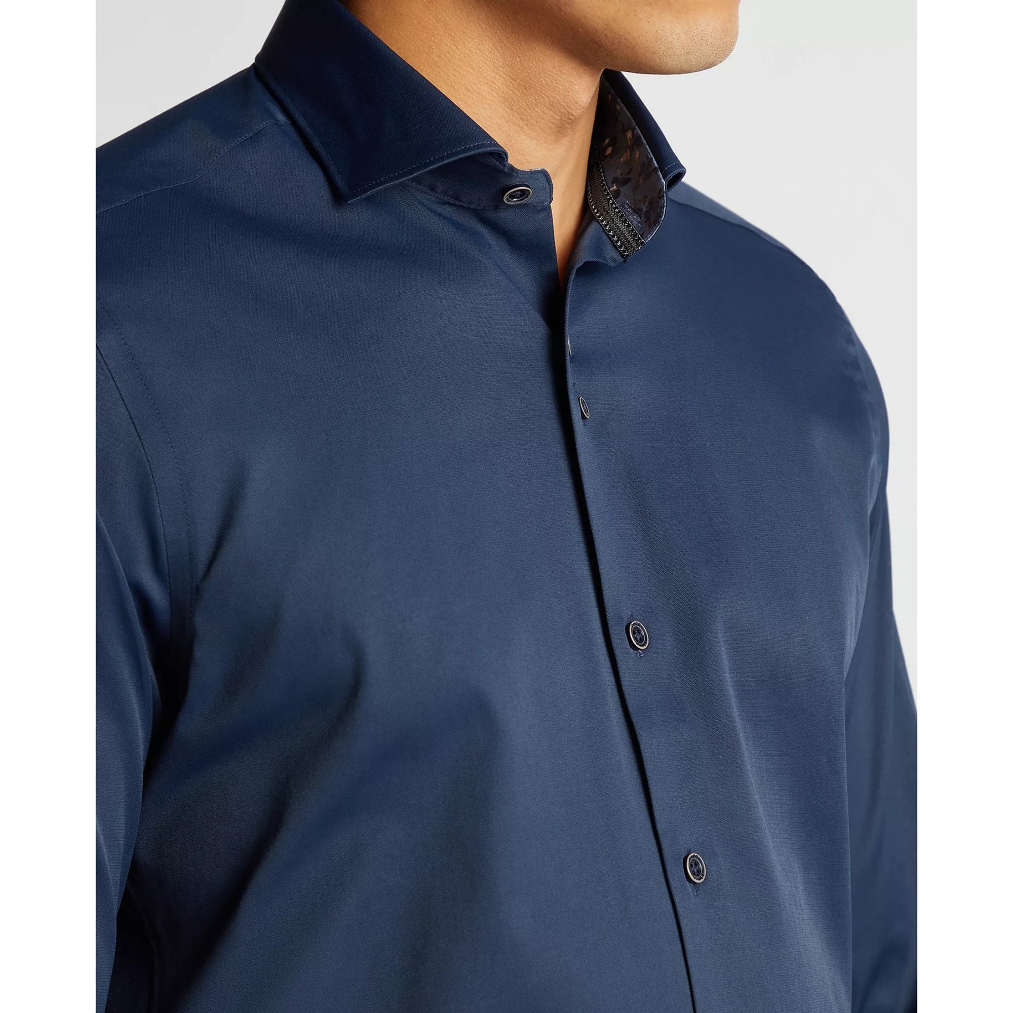 Navy blue button-up shirt on a white background