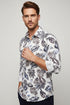 Floral patterned shirt with brand label on a white background