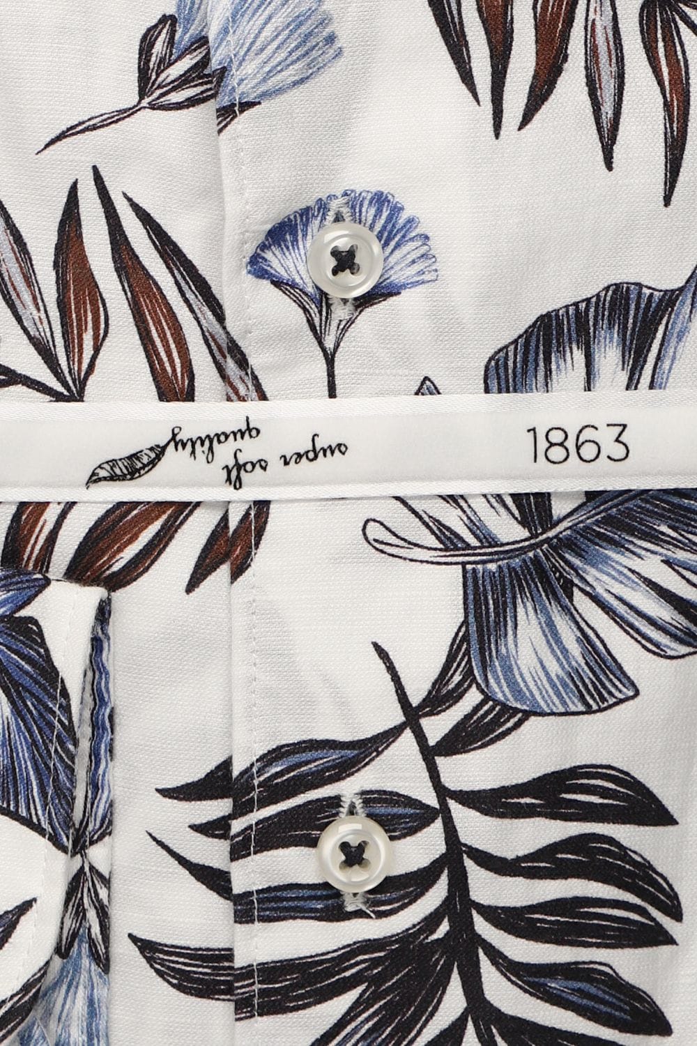 Close-up of a shirt with floral pattern and brand label.