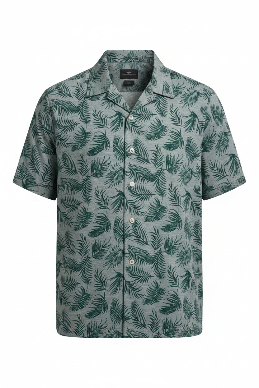 Green polo shirt with leaf pattern on a white background