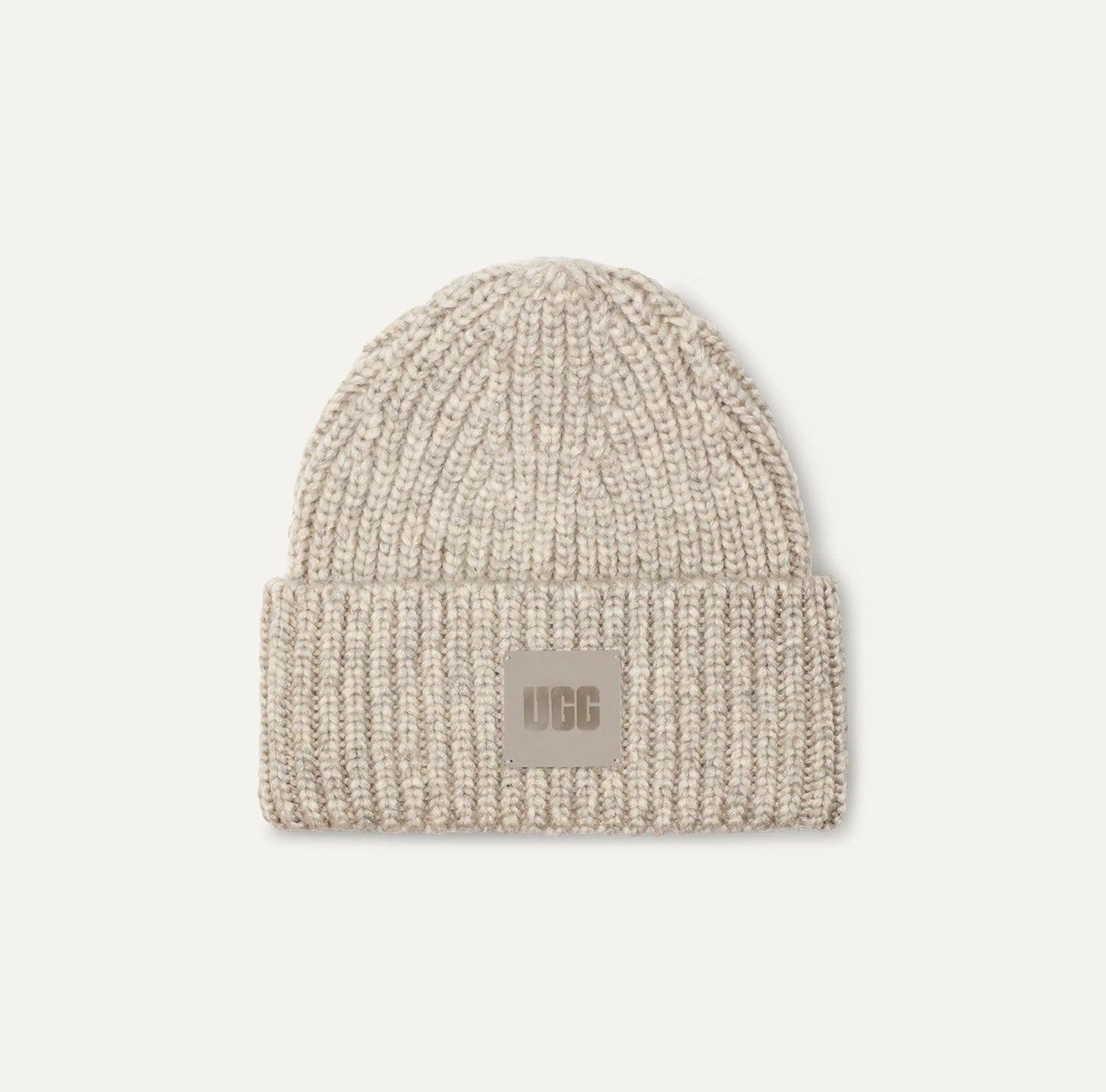 Beige knit beanie with UGG logo on a light gray background