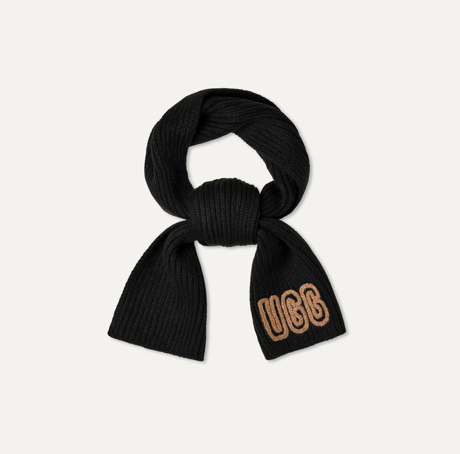 Black knitted scarf with 'UGG' branding on a light gray background