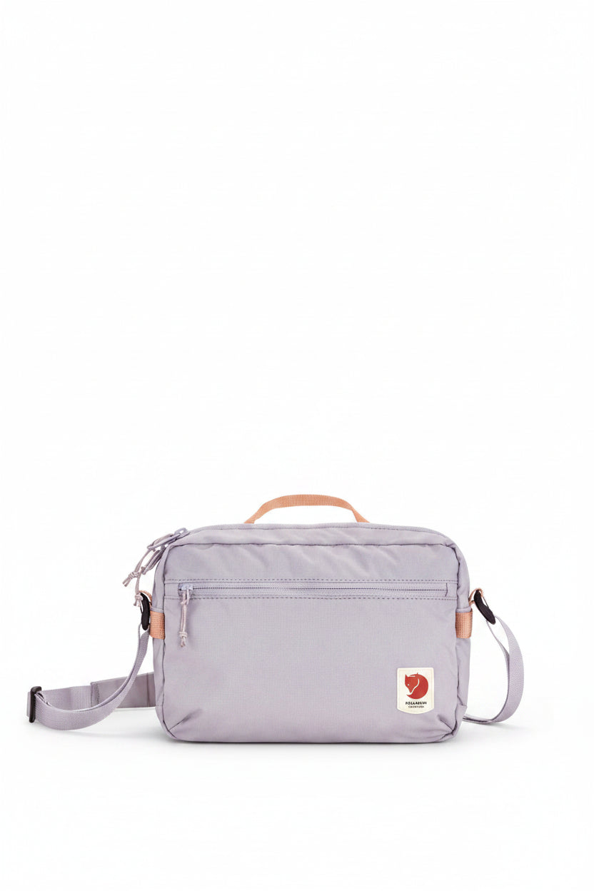 Lavender crossbody bag with visible brand logo on a white background