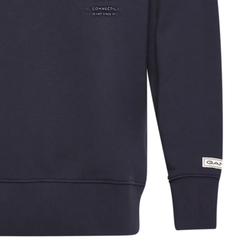 Navy blue sweatshirt with brand logo on sleeve against a white background