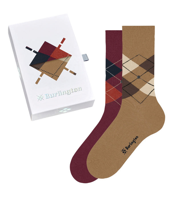 A pair of Burlington crew socks shown with their branded white gift box on a clean white background. The socks feature an argyle pattern in tan, burgundy, dark navy, and rust red, with the Burlington logo printed near the foot.