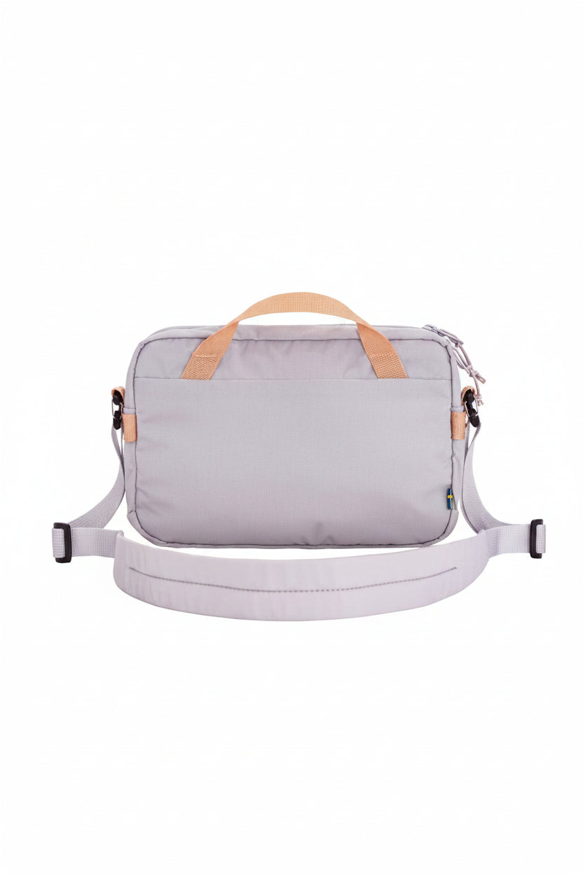lavender bag with orange handles and a white strap on a white background