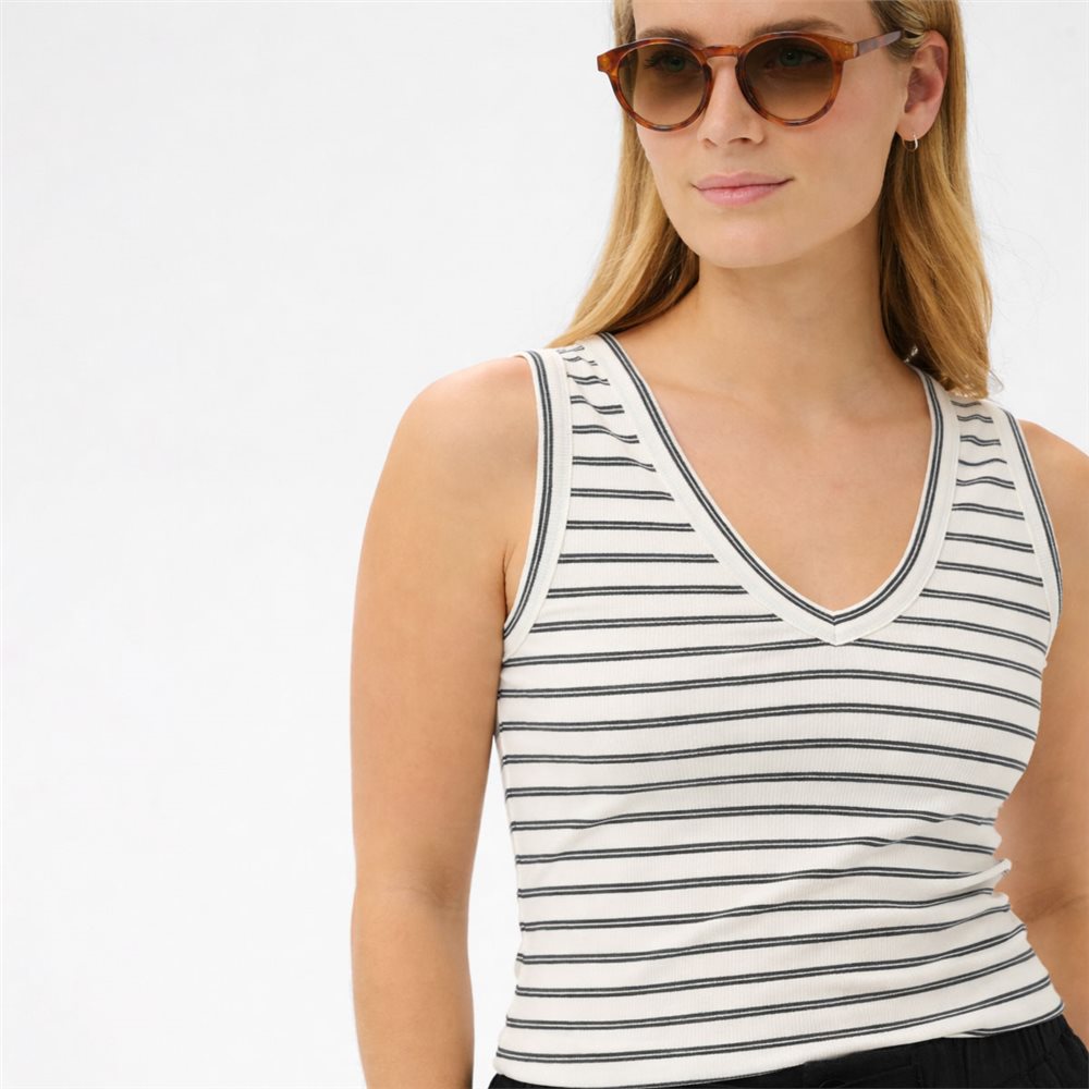 Woman wearing a striped tank top and sunglasses on a white background
