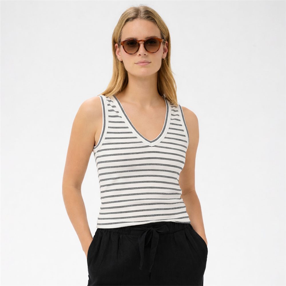 Woman wearing a striped tank top and sunglasses on a white background