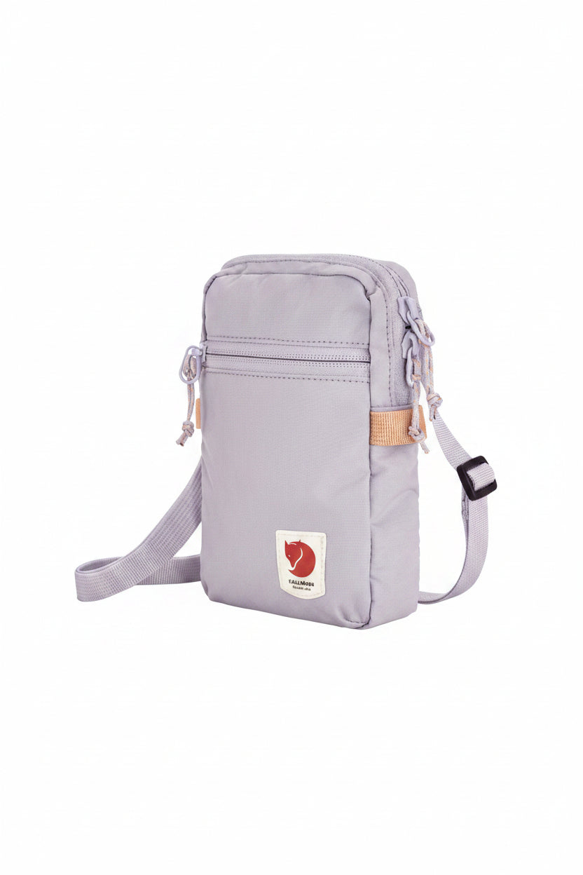 Lavender crossbody bag with visible brand logo on a white background