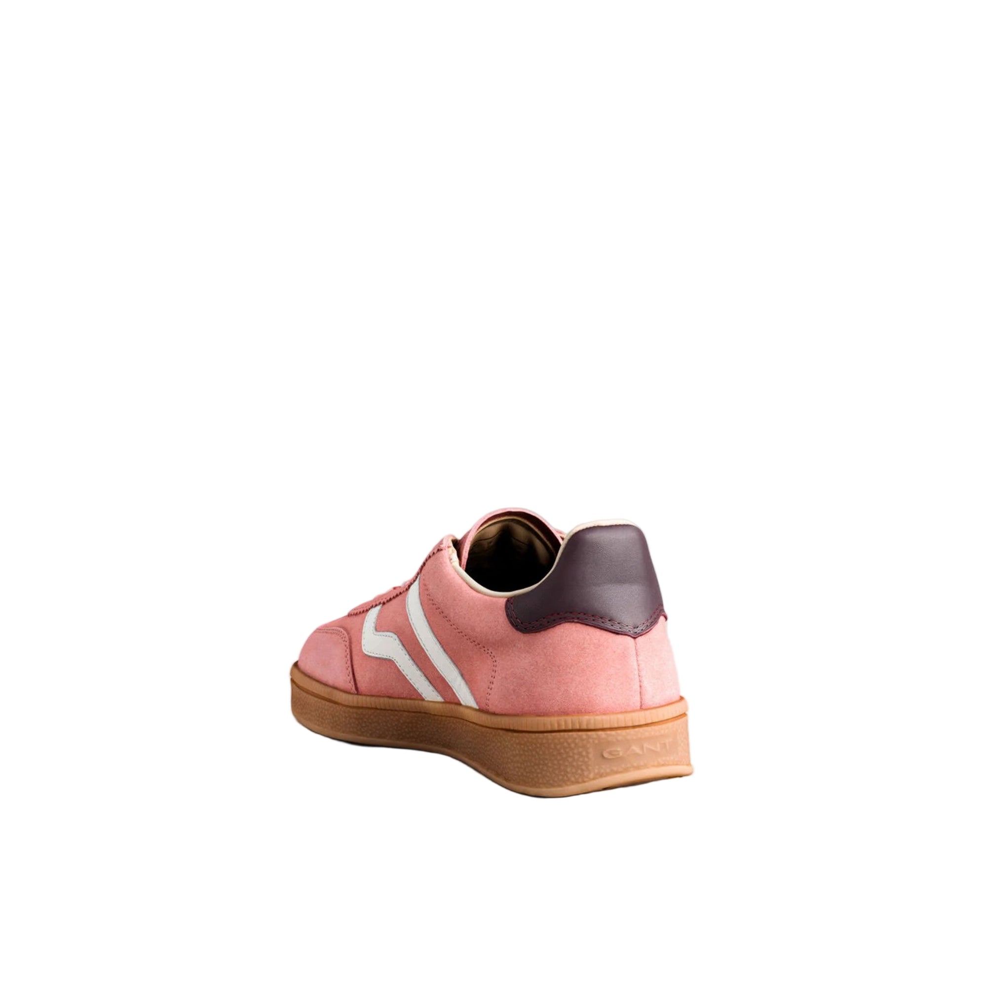 Pink sneaker with white stripes on a light gray background