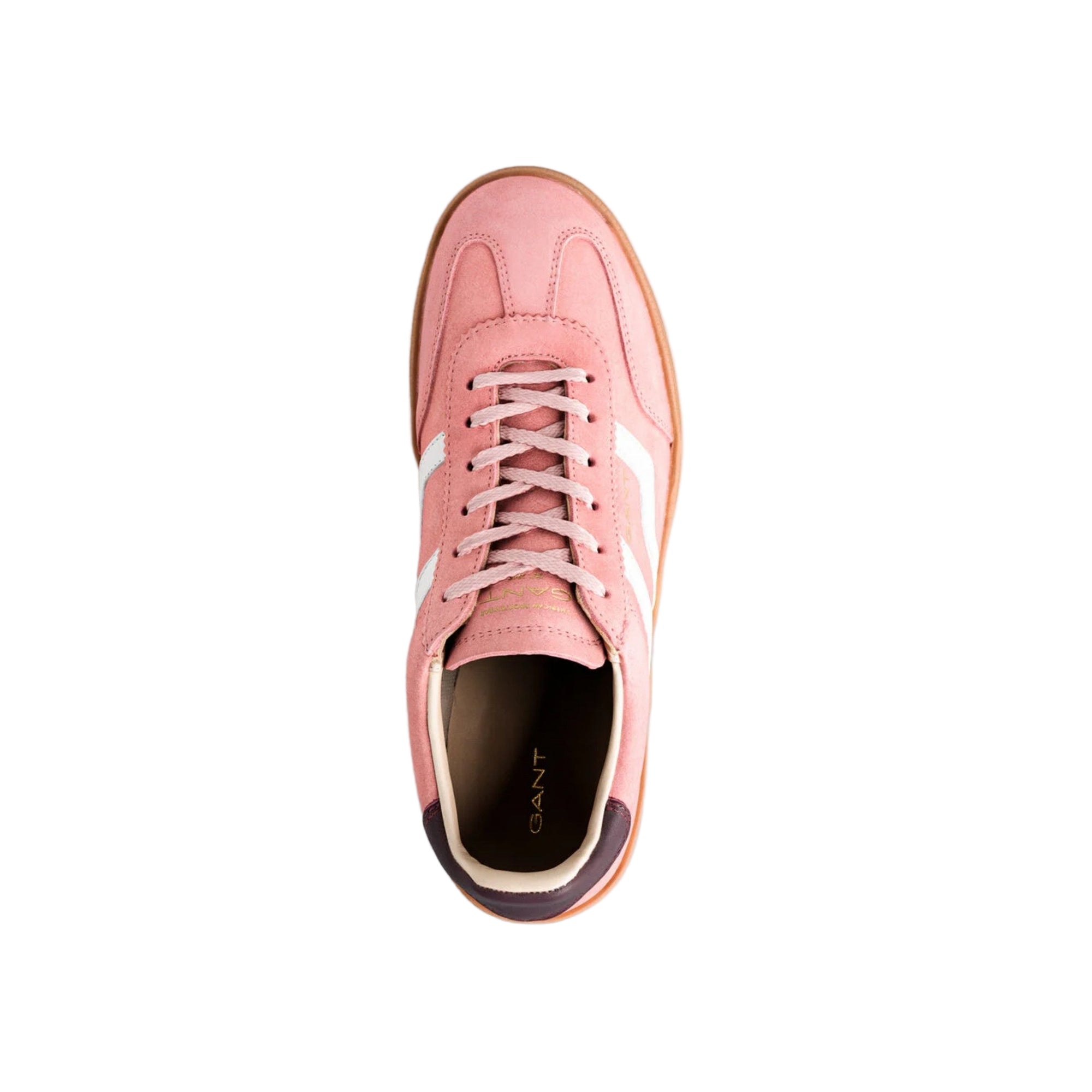 Pink sneaker with white laces on a light gray background