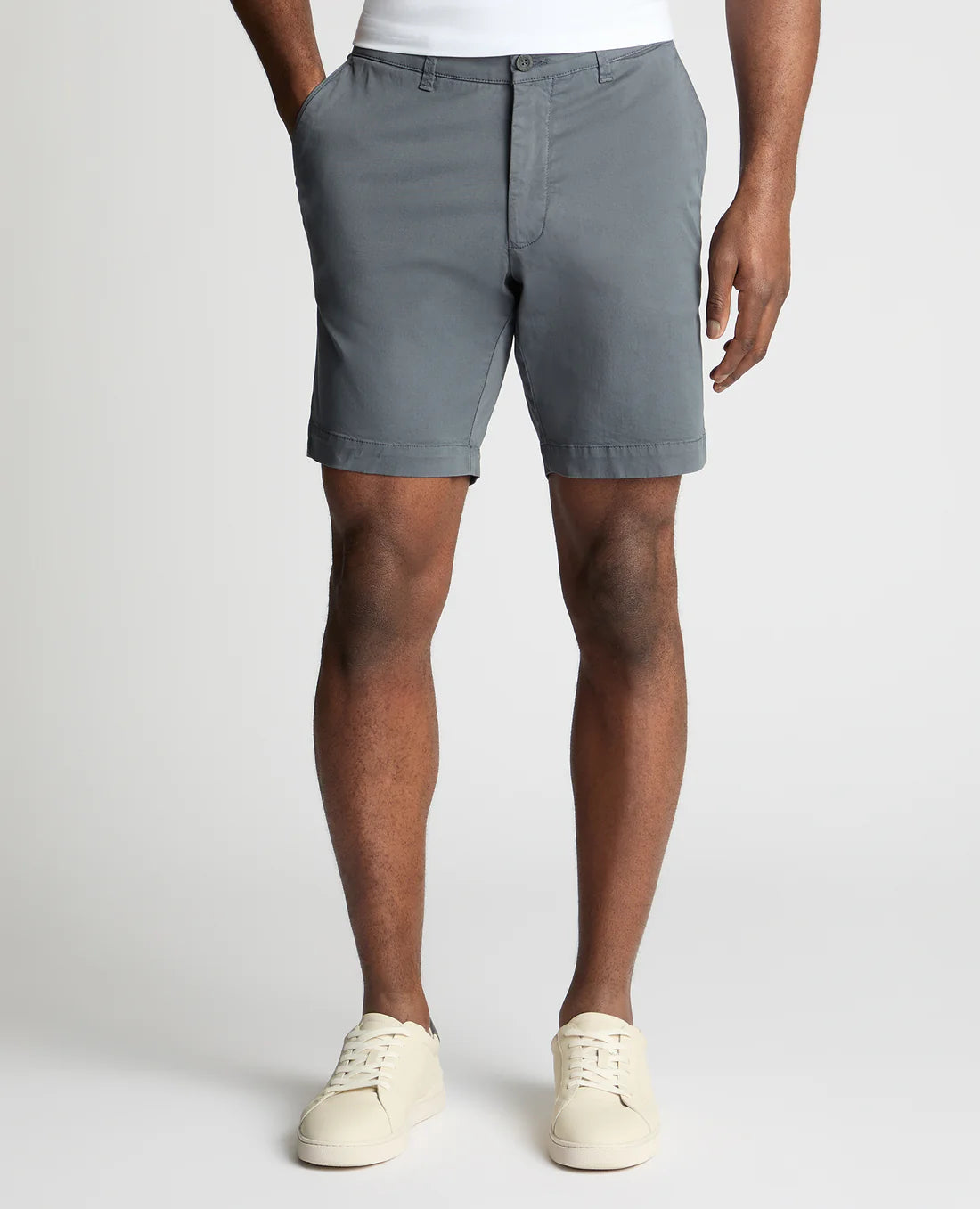 Person wearing gray shorts on a white background