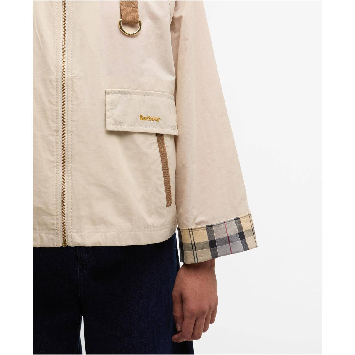Beige jacket with plaid cuff and Barbour logo on a white background