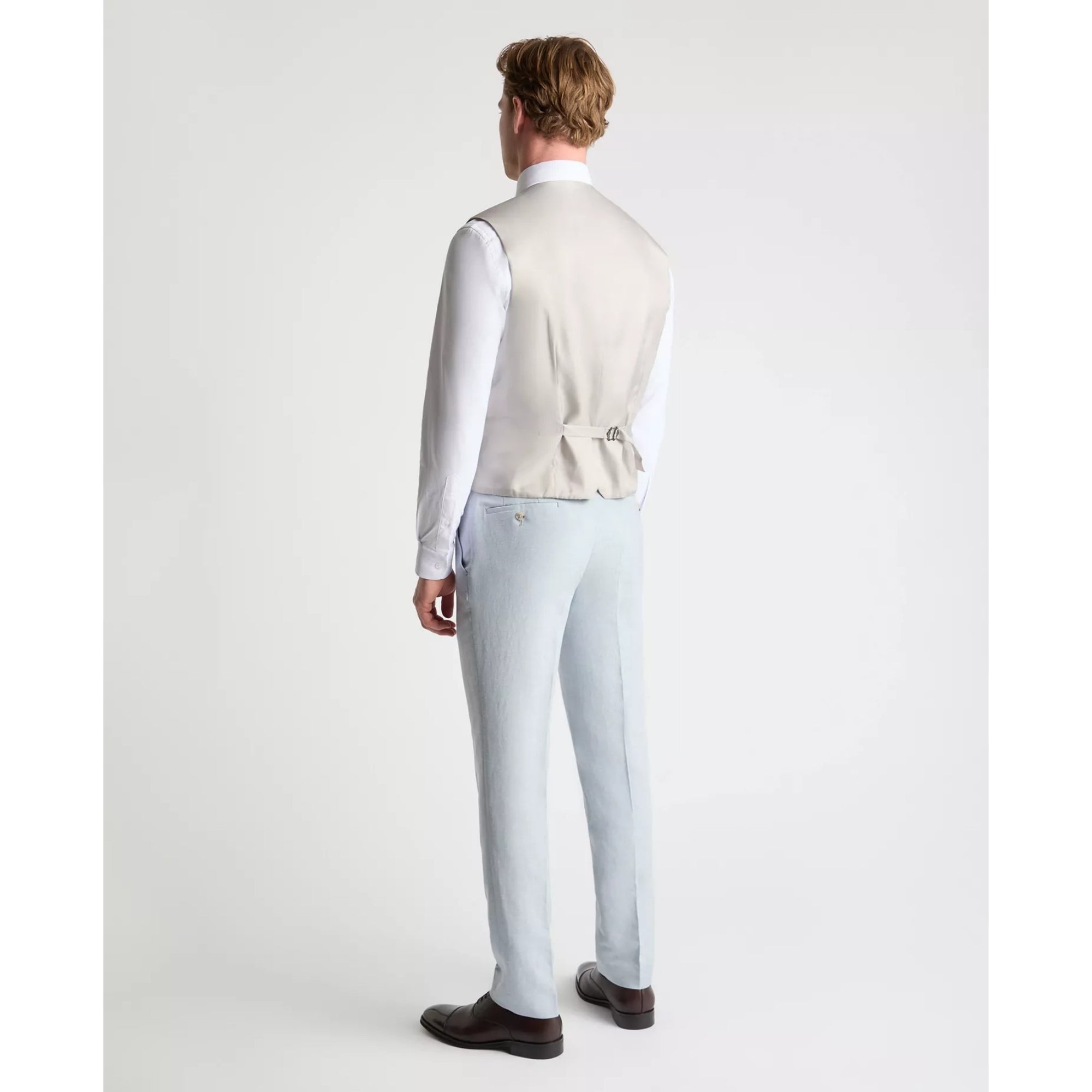 Man wearing a sky blue vest and pants on a white background