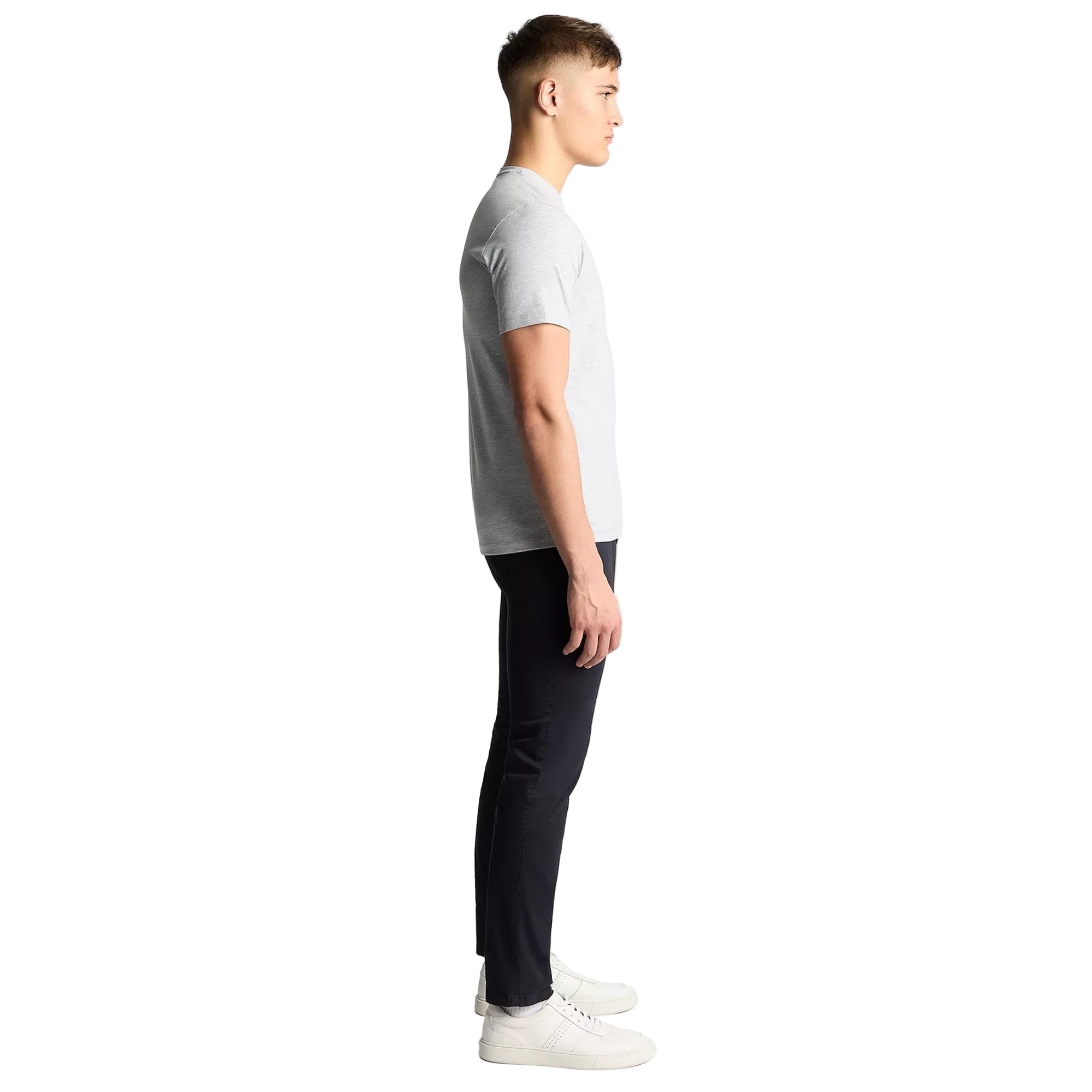 Person wearing a gray t-shirt and black pants on a white background
