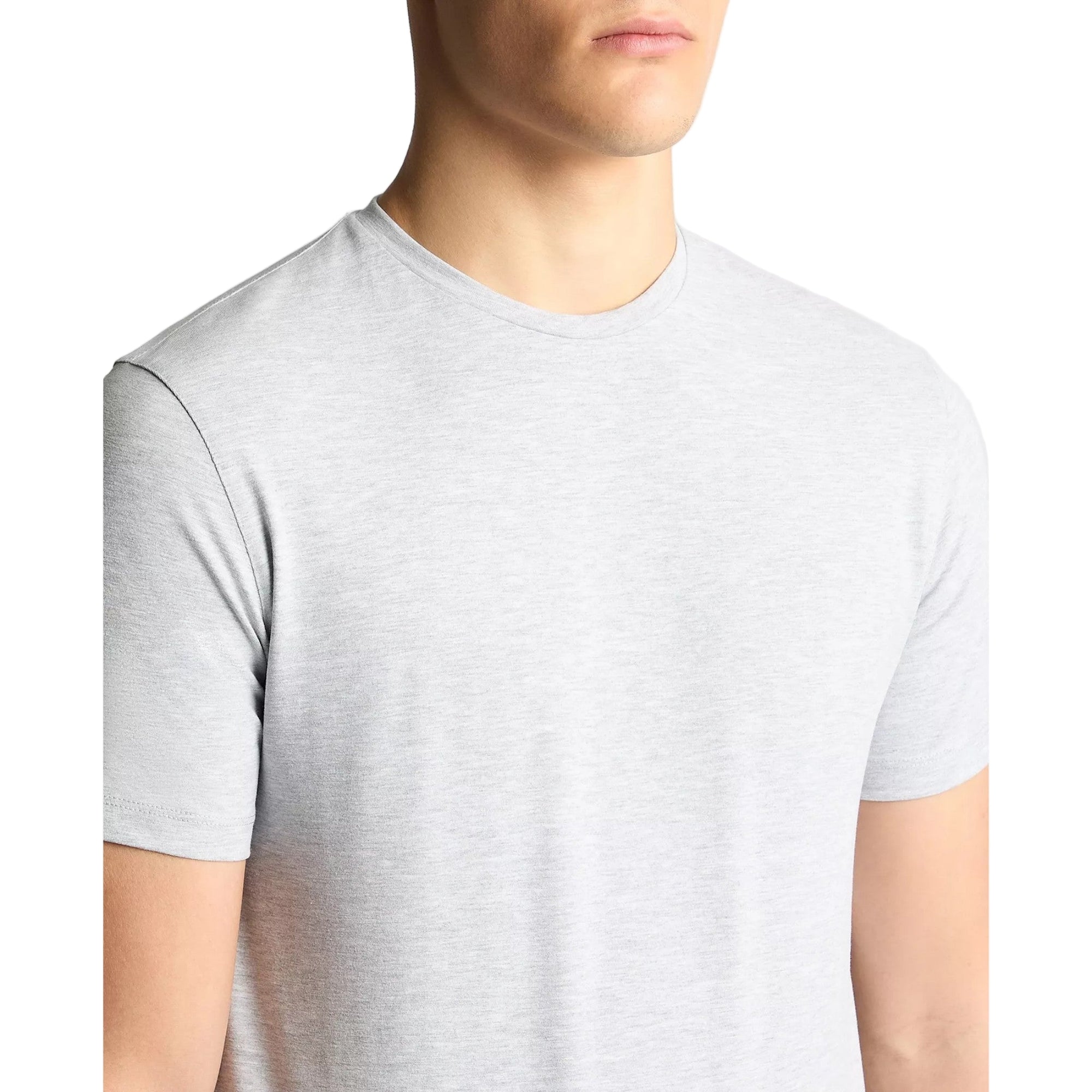 Gray t-shirt worn by a person on a plain background