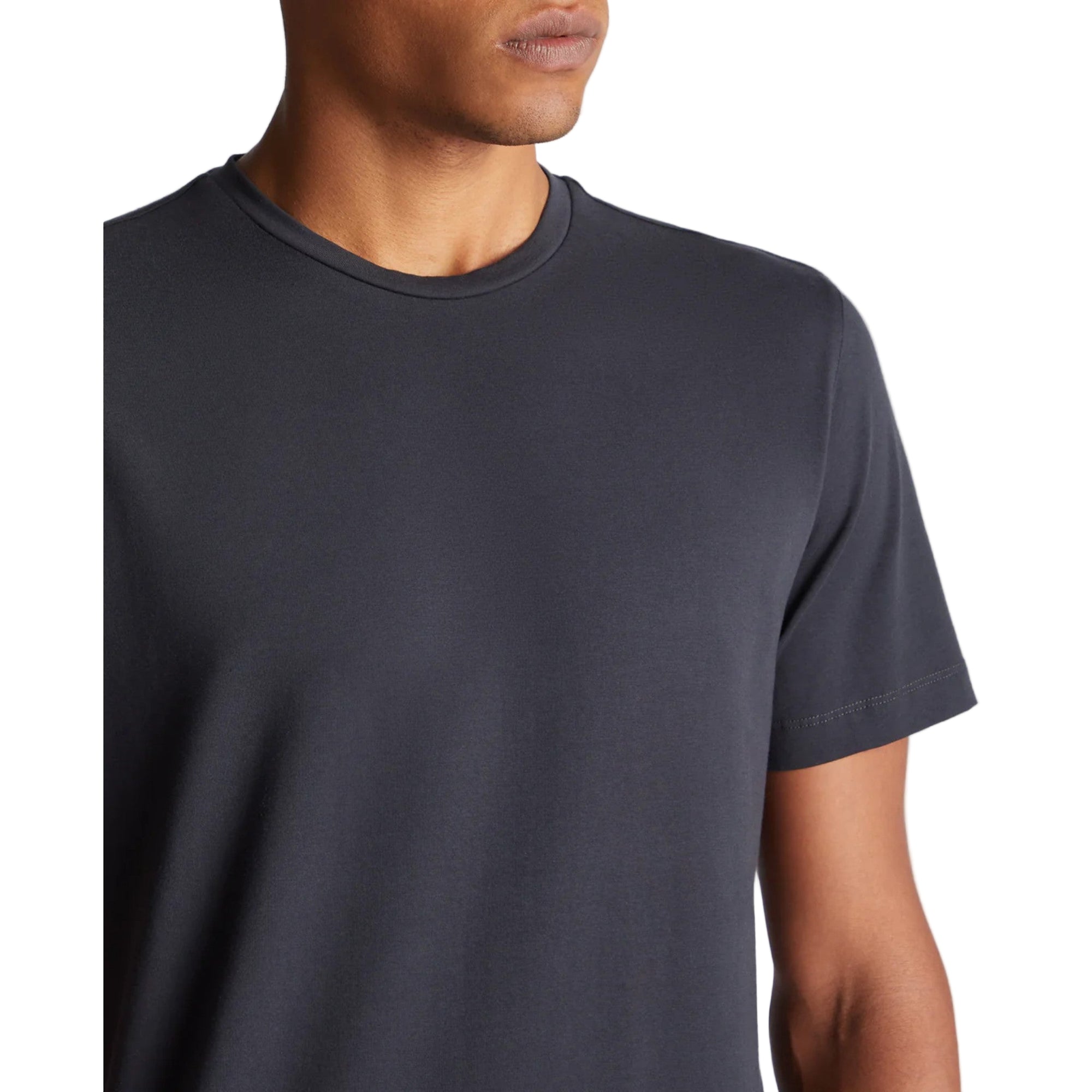 Person wearing a plain dark gray t-shirt on a light gray background