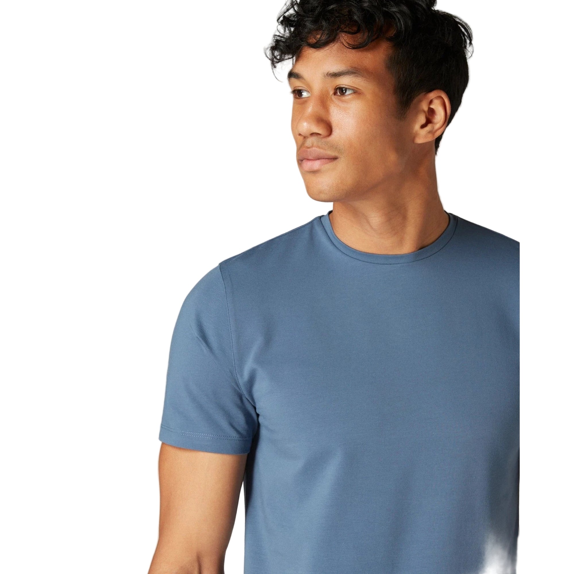 Man wearing a blue t-shirt against a plain background