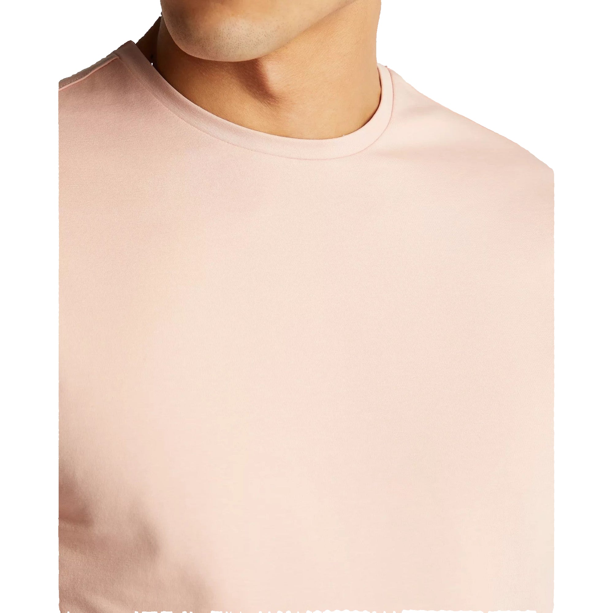 Close-up of a person wearing a light pink t-shirt against a plain background