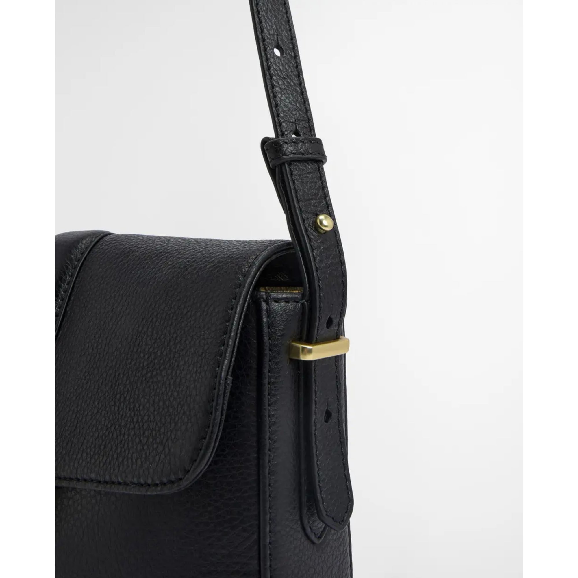 Black leather bag with a gold buckle on a white background
