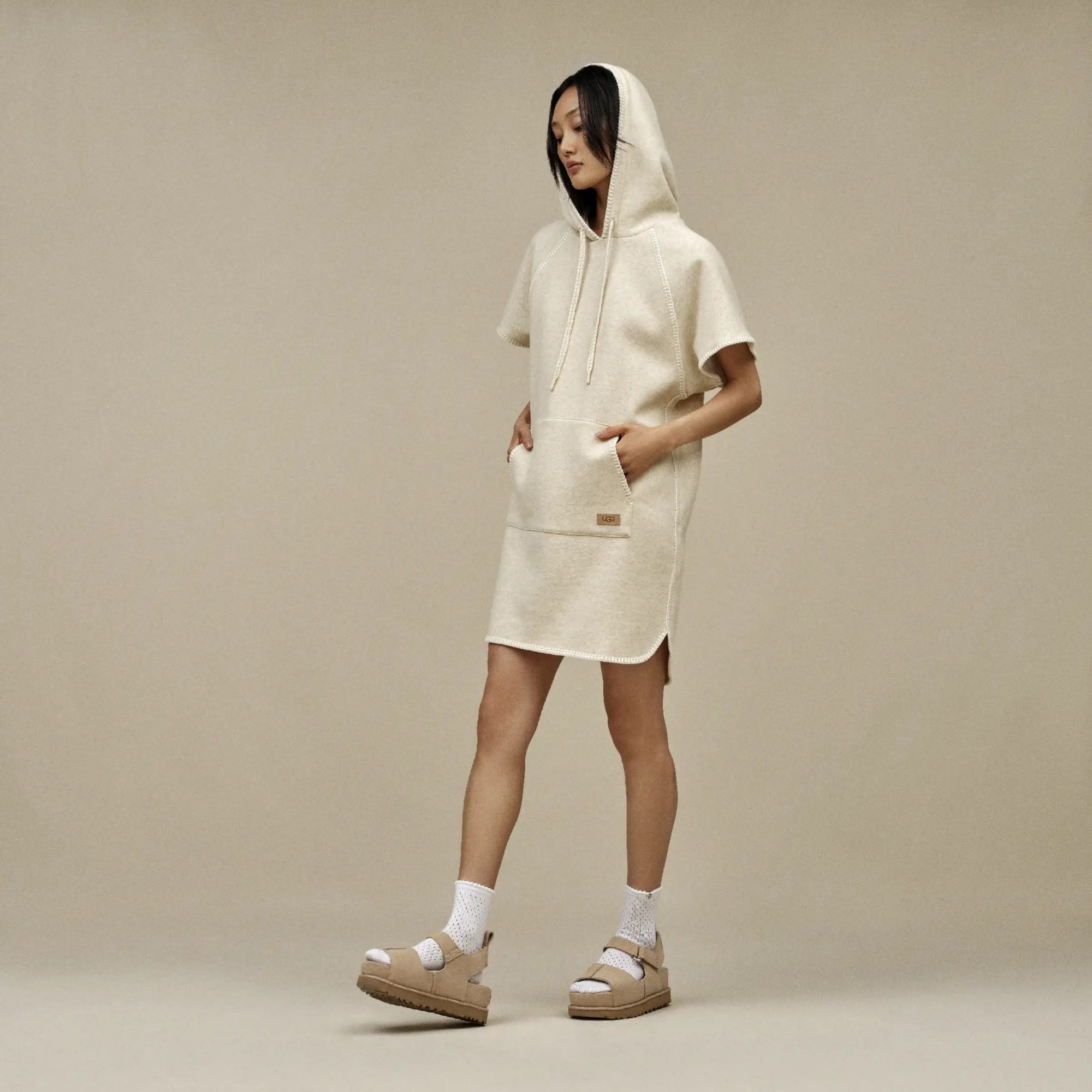 A beige Ugg Goldenstar sandal with an adjustable ankle strap and hook-and-loop closure.