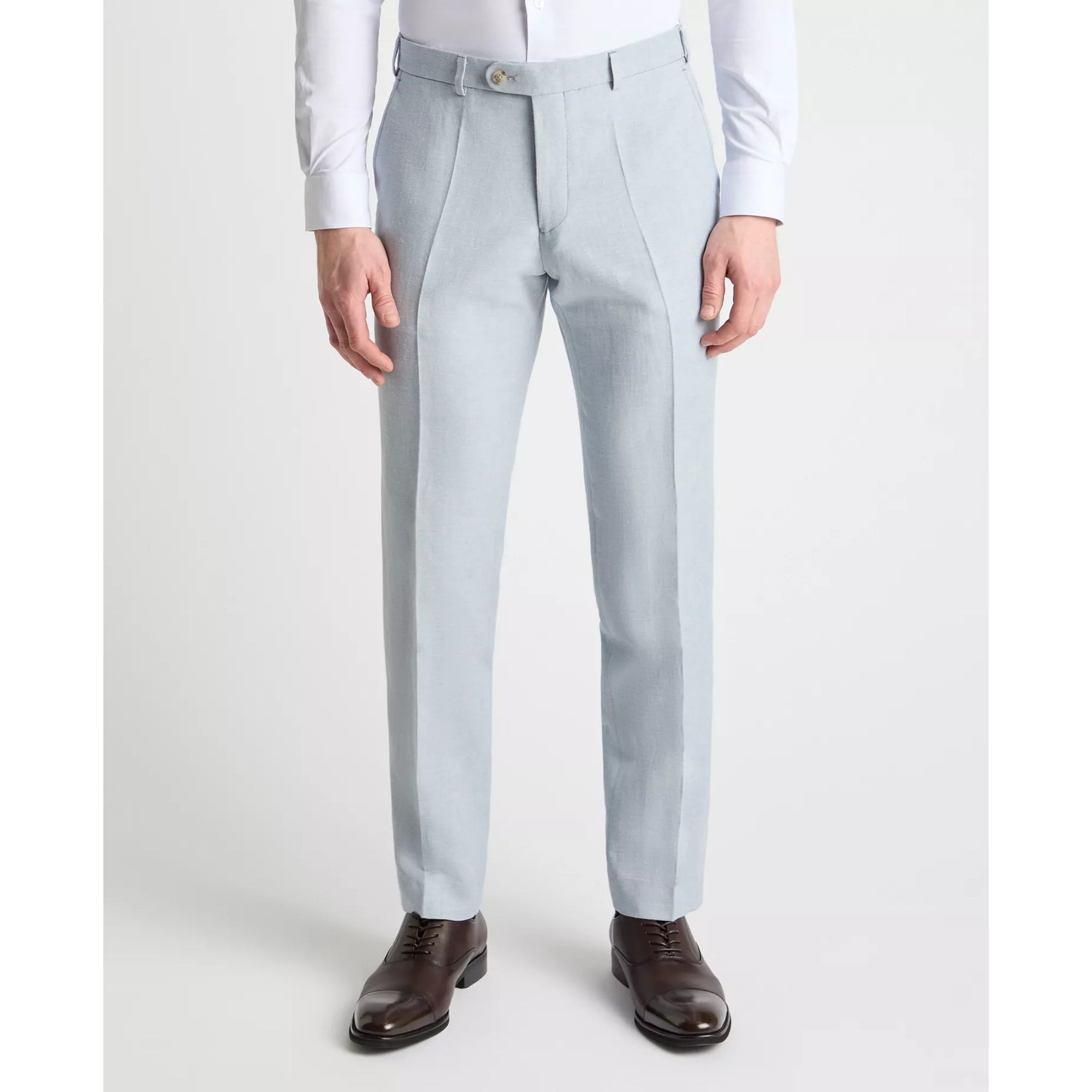 Light blue dress pants worn with a white shirt and brown shoes on a white background