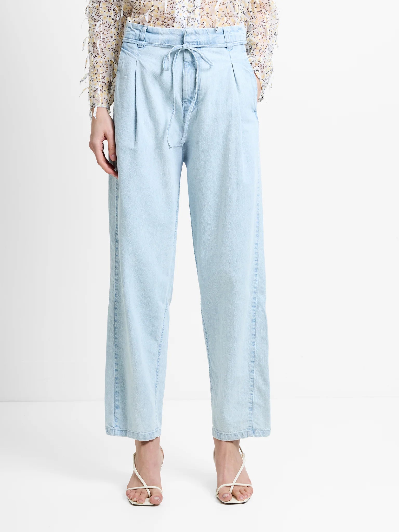 Light blue denim pants worn by a person on a white background