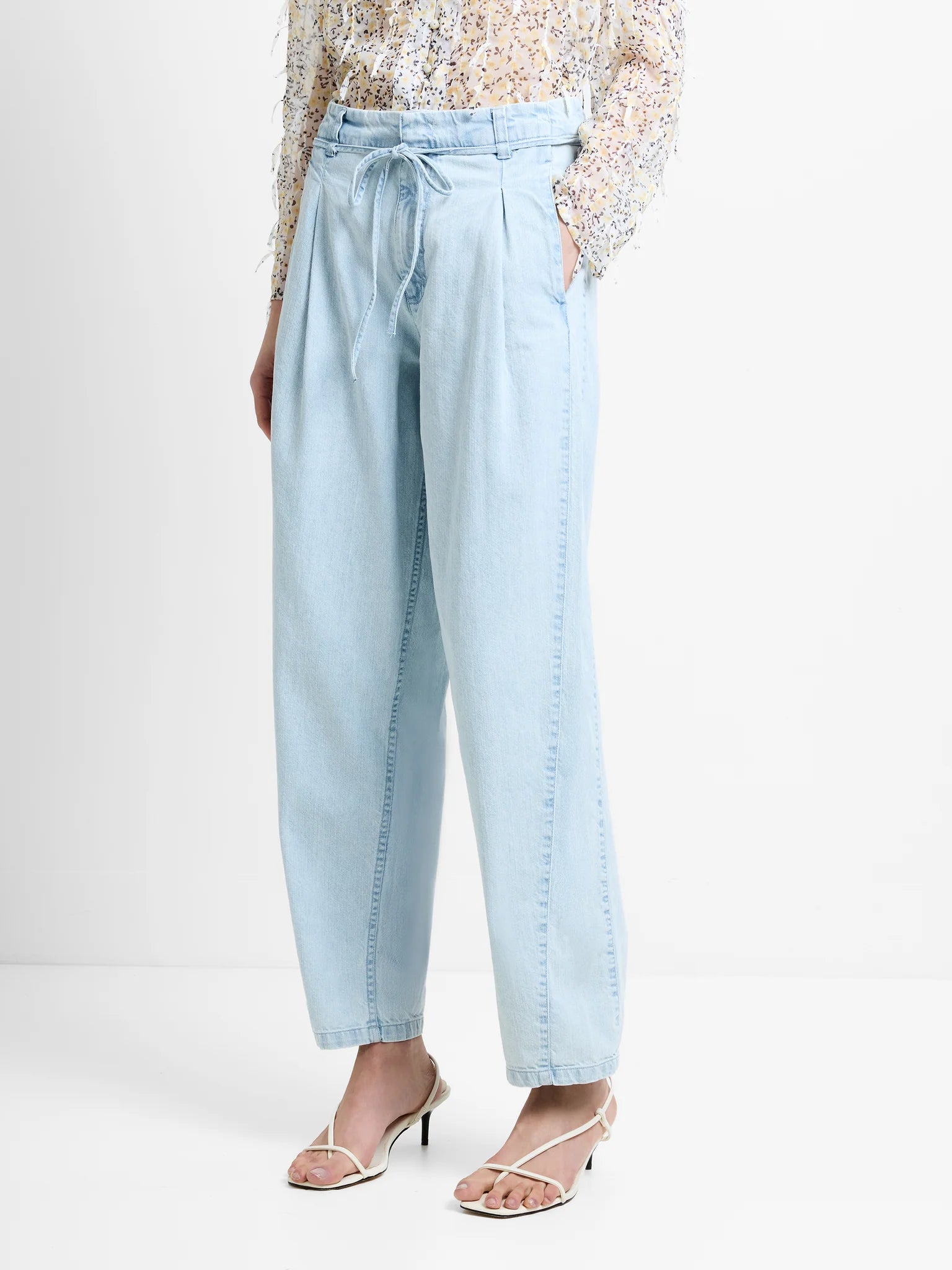 Light blue pants worn by a person on a white background