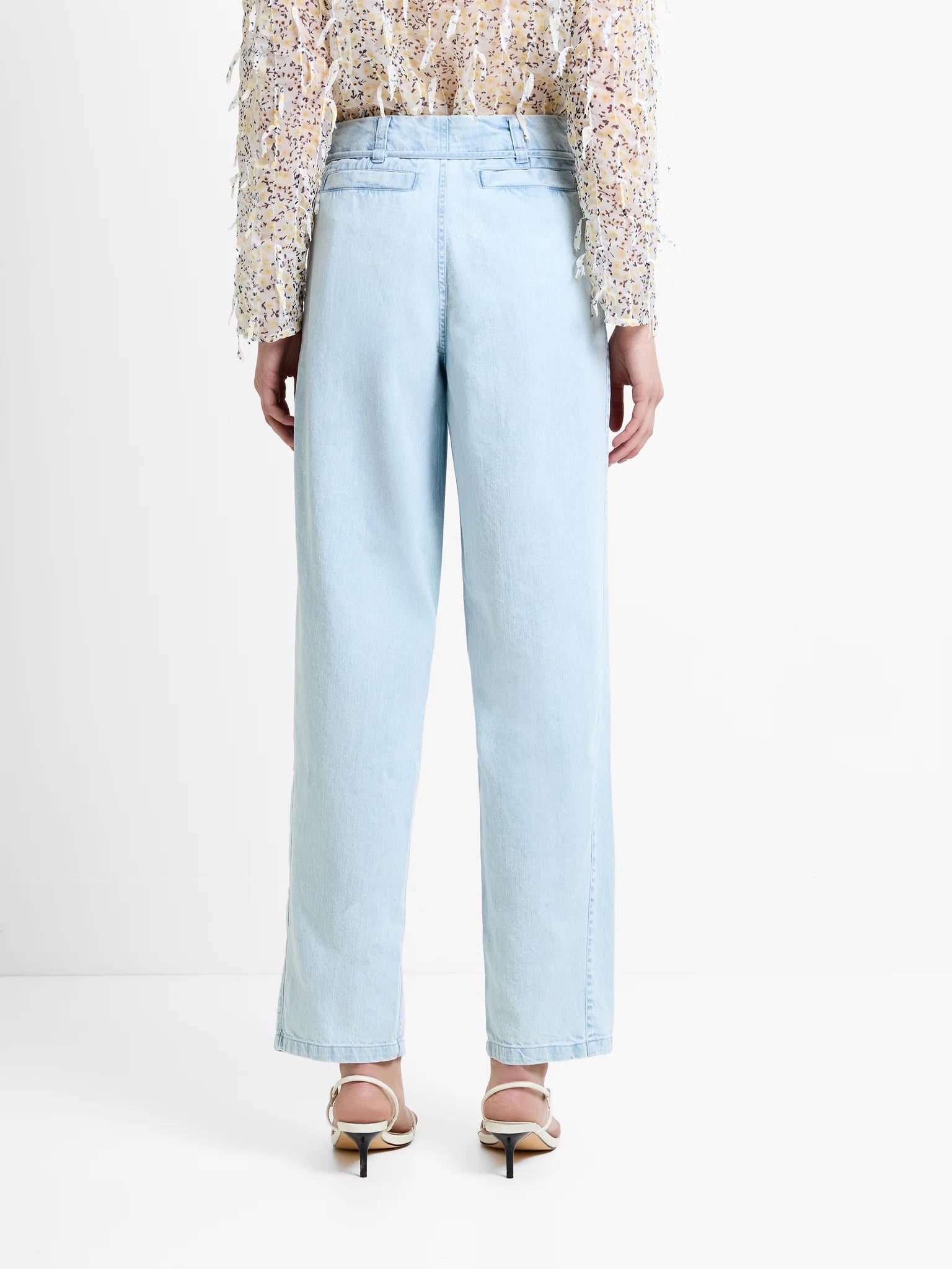 Light blue jeans worn by a person on a white background