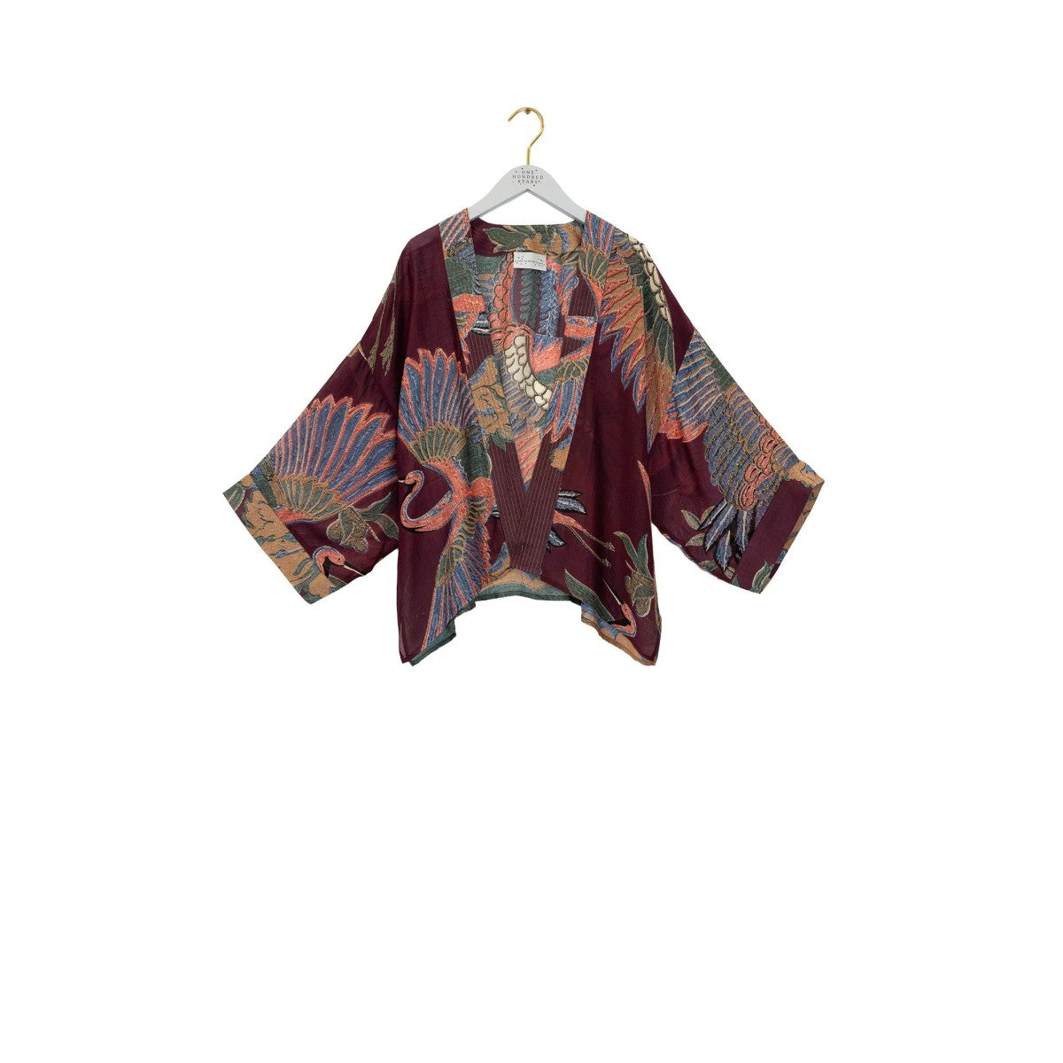 Colorful kimono-style garment on a hanger against a white background