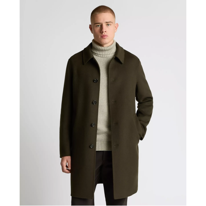 Man wearing a Remus Uomo green coat over a light sweater on a white background