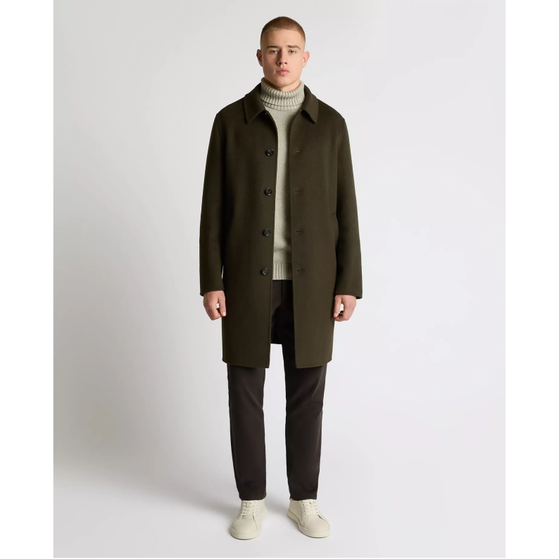 Man wearing a dark green Remus Uomo coat over a light sweater on a white background