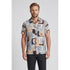 Man wearing a patterned shirt with abstract designs on a plain background