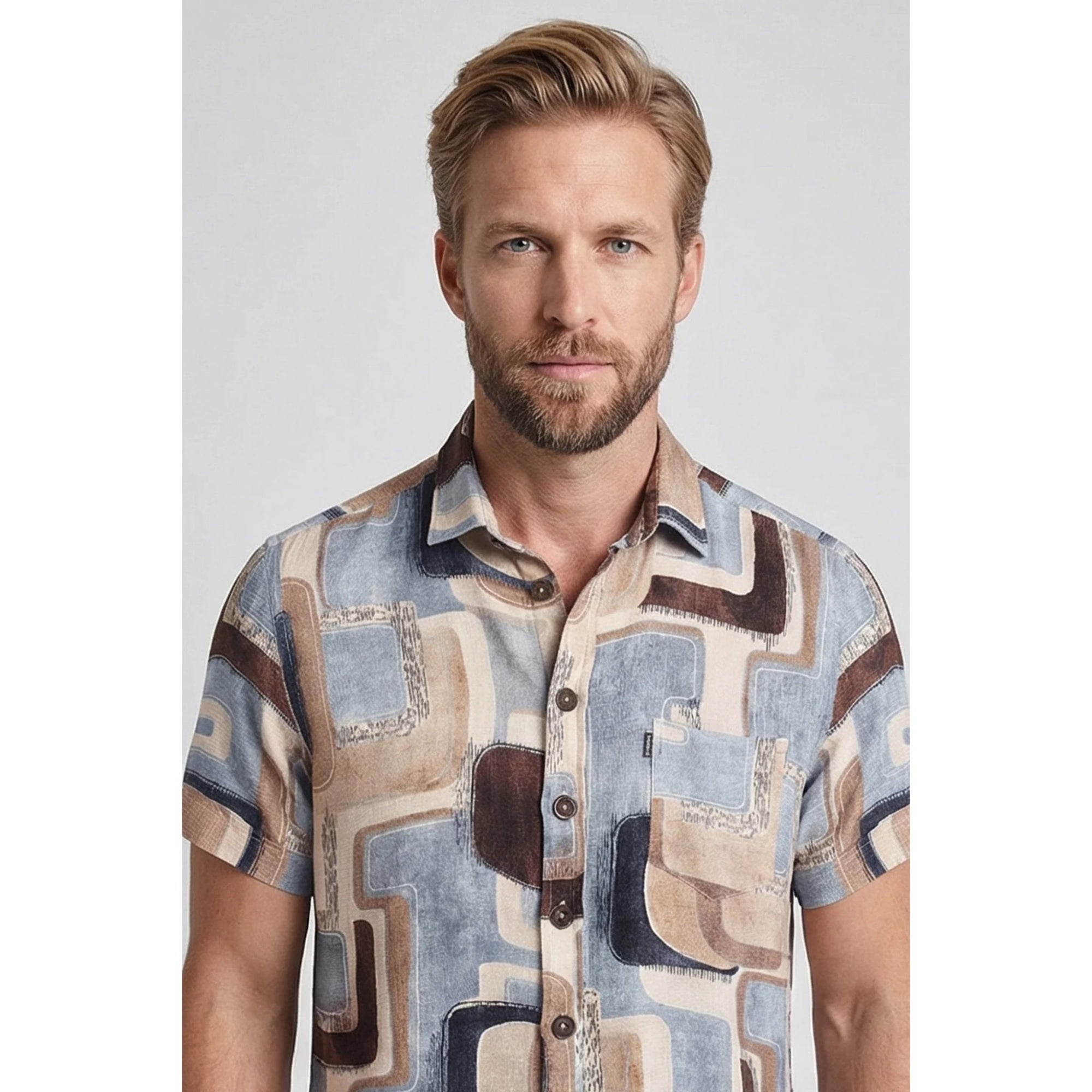 Man wearing a patterned shirt on a plain background