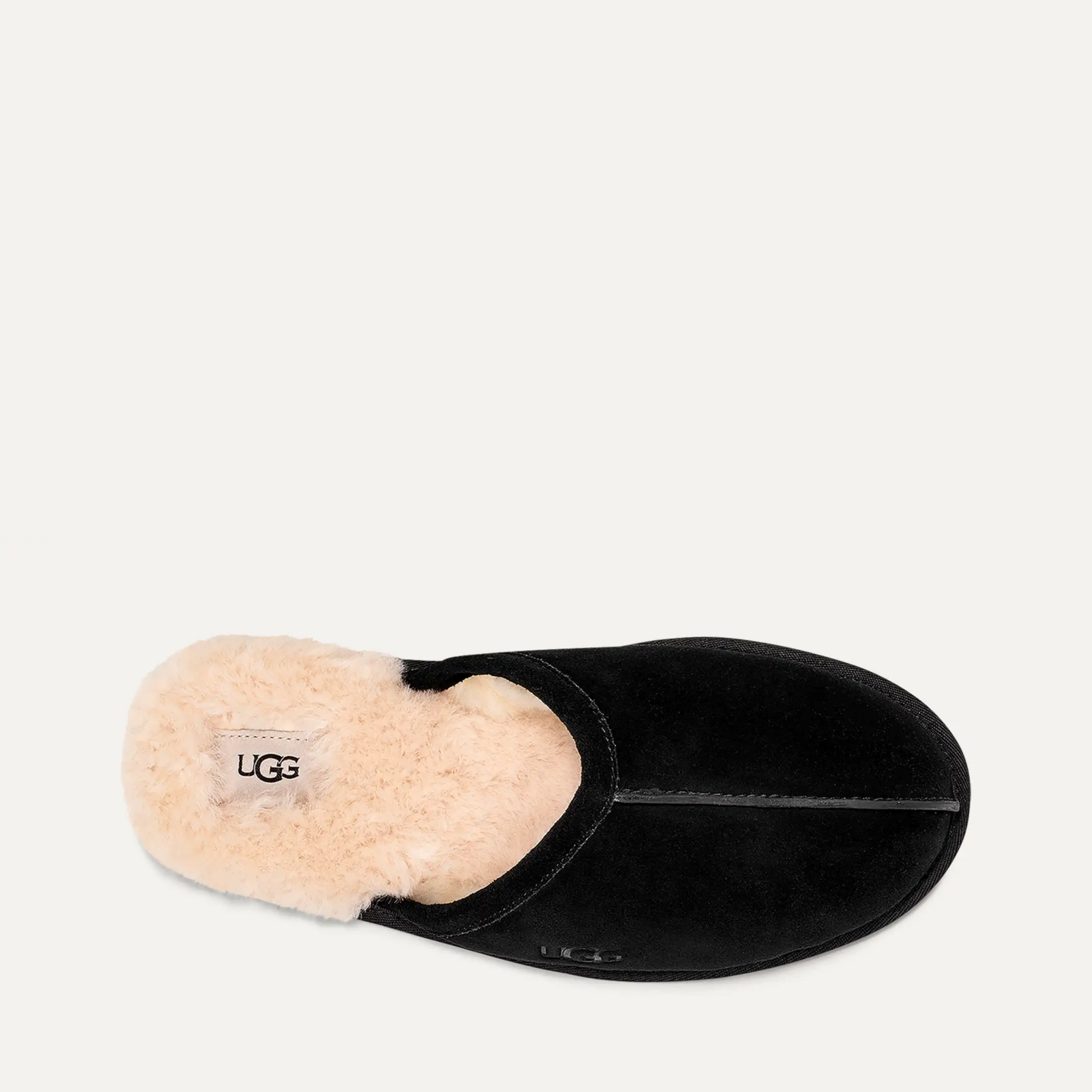 Black slipper with beige interior on a light gray background