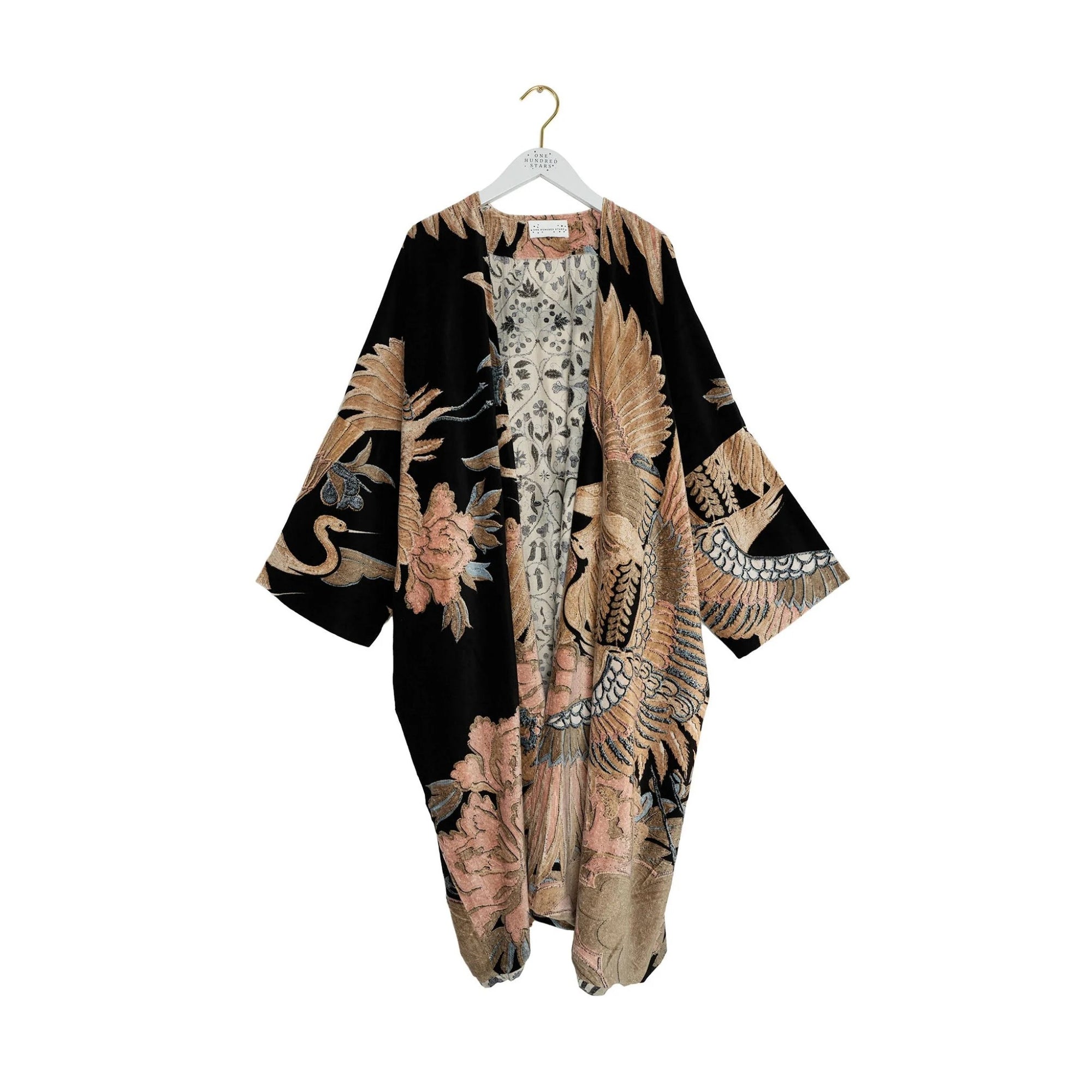 Kimono-style garment with intricate patterns on a hanger against a white background