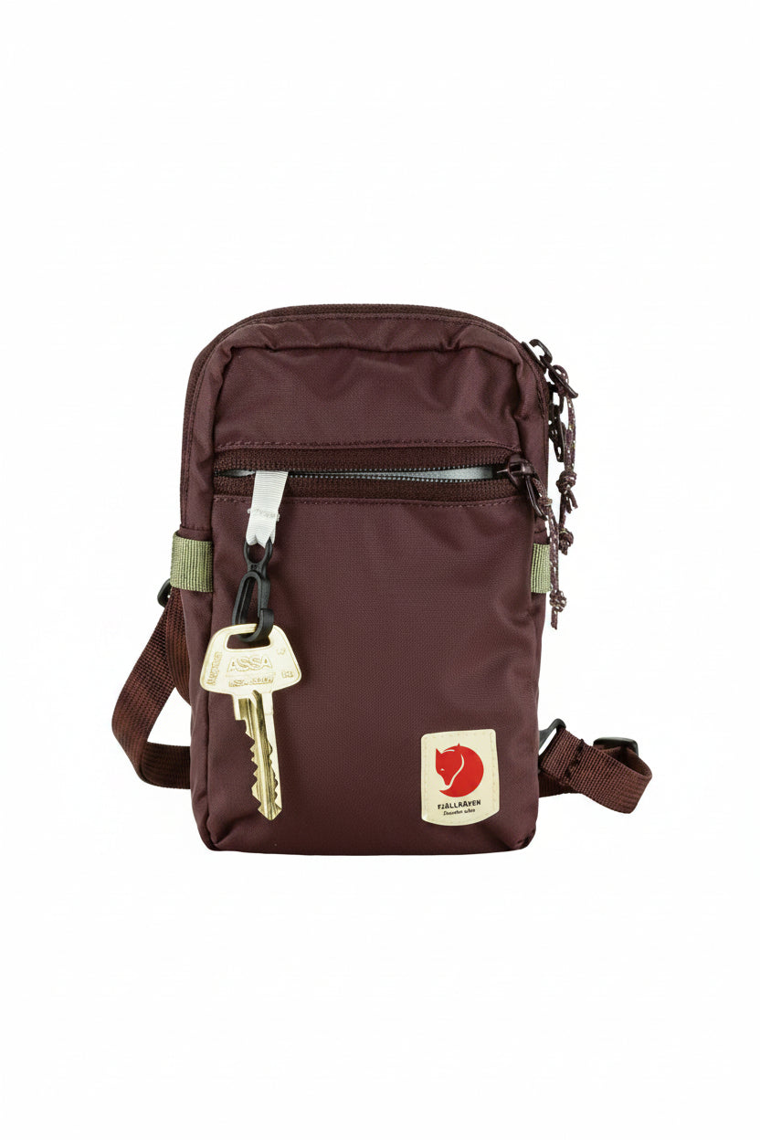 Brown pouch with key and visible brand logo on a white background