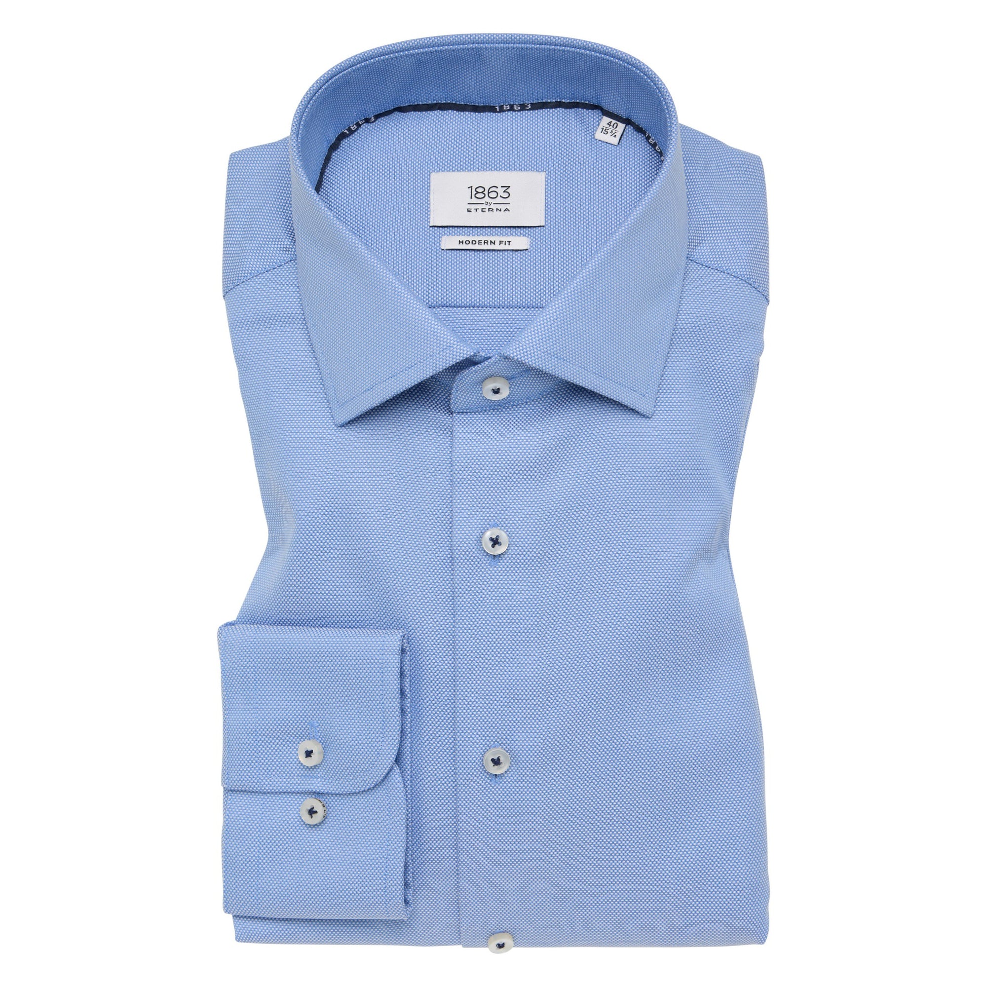 Folded light blue dress shirt with collar and cuff details on a white background