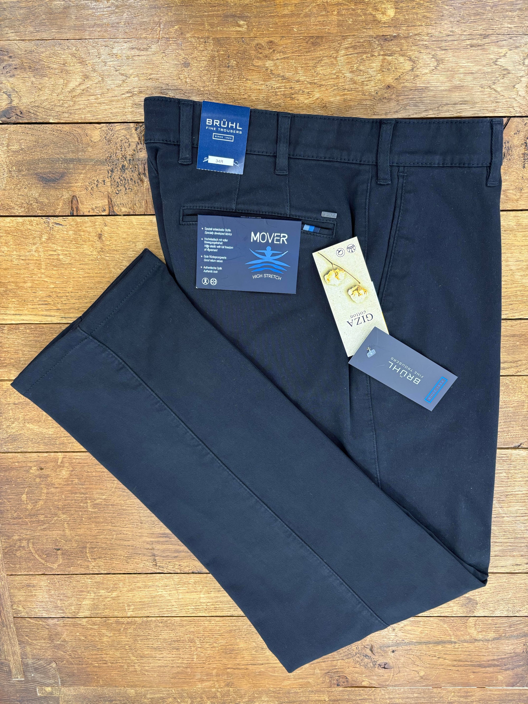 Bruhl navy chinos with tags on a wooden surface