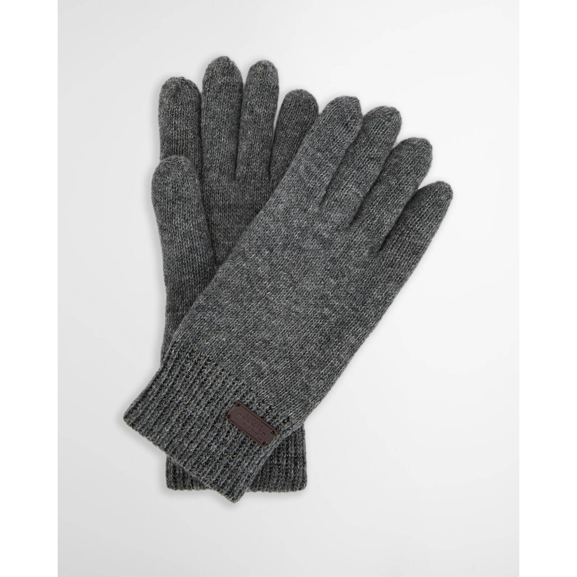 Pair of gray gloves with a small brown label on a white background