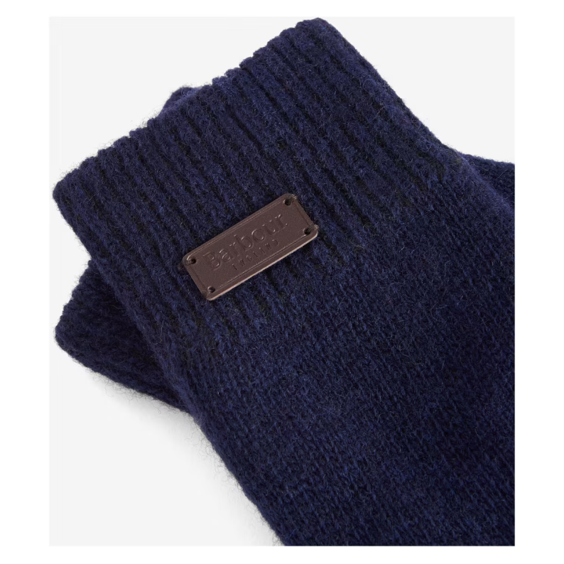 Navy blue knitted glove with a brown leather patch on a white background
