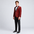A man wearing a red velvet tuxedo jacket with black satin lapels and black satin buttons. Slim fit