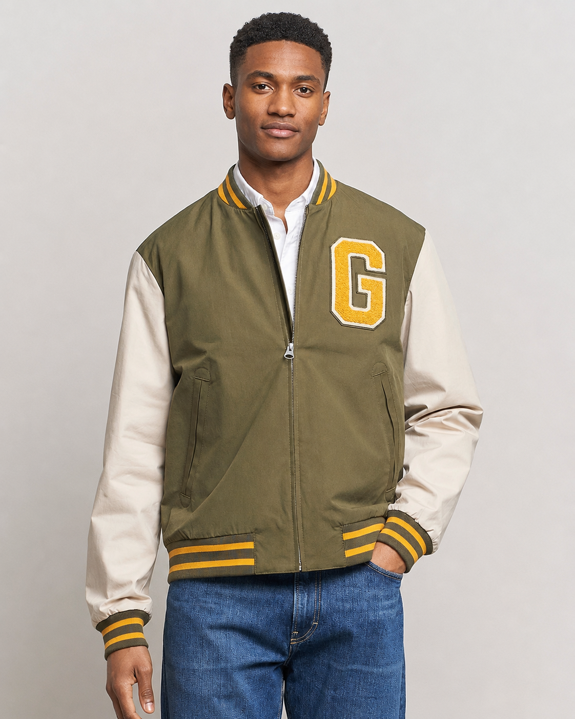 Man wearing a Gant Varsity Jacket in Soft Oat and Olive